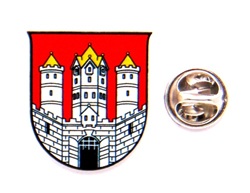 Wappen mit rotem Hintergrund, weißen Türmen und goldener Münze mit Adlermotiv daneben.